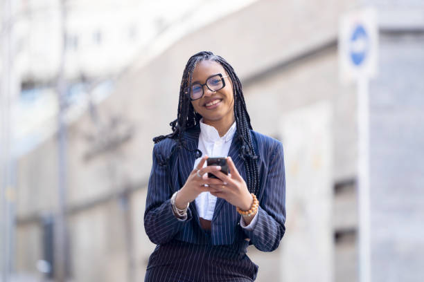 istock Woman with blur background using mobile phone in the city 1457713338