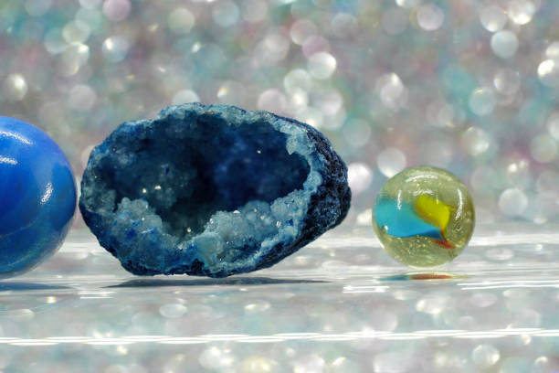 istock Glass balls and colorful marbles against a light background 1457713420