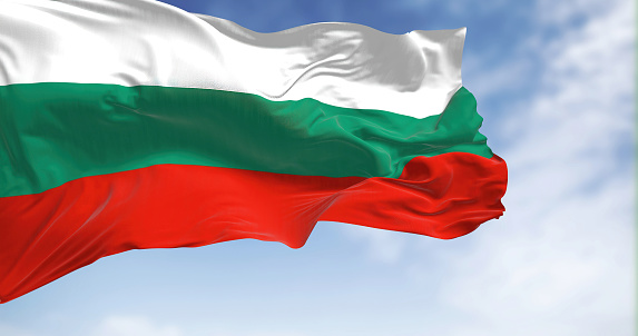 Close-up view of the Bulgaria national flag waving in the wind. Bulgaria flag is white-green-red horizontal stripes. Rippled fabric. Textured background. Realistic 3d illustration