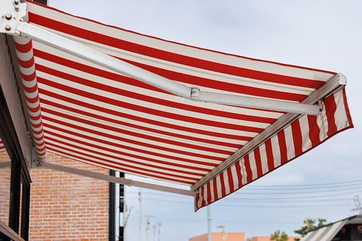 white and red strip awning. out door canvas roof.