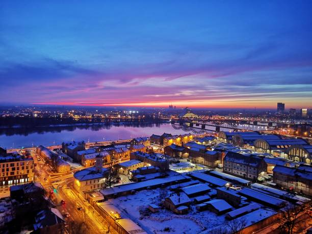 Snowy Rīga roofs and towers in the dusk.