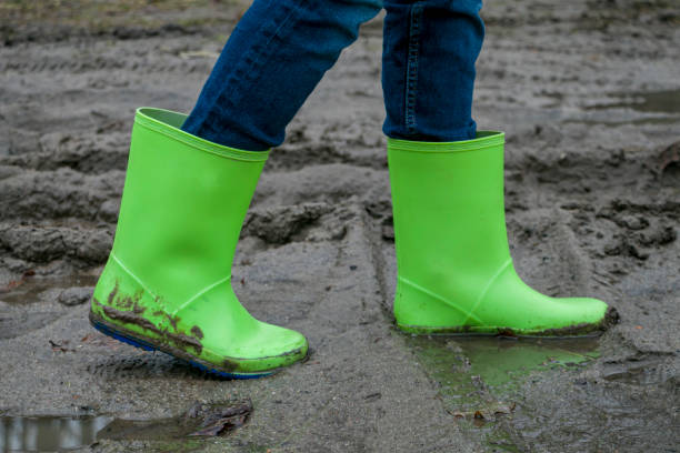 istock rubber boots of green color in the mud 1457718680