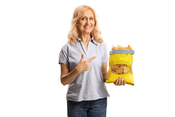 istock Woman holding a pack of tortilla chips and pointing 1457719781