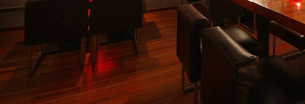 istock Wooden floor and black leather chairs at cellar restaurant at night 1457720298