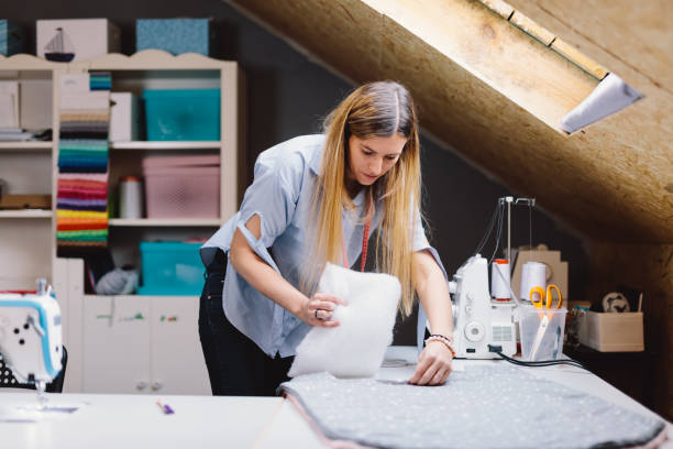 istock Seamstress woman working with cloth in clothes sewing workshop 1457722473