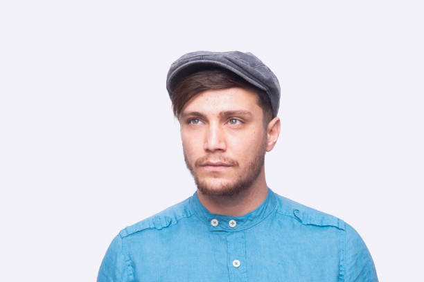 istock Portrait of a young man looking away with a blank expression over gray background 1457723206