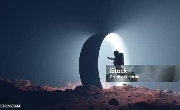 Astronaut On Alien Planet Entering Spacetime Portal Light Stock Photo - Download Image Now