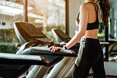 Fitness asian women running on track treadmill, exercise fitness. Fitness, gym, workout and healthy lifestyle concepts.
