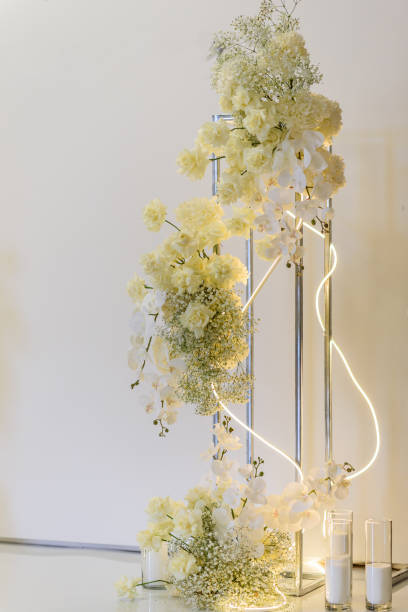 istock Wedding reception for luxury ceremony. Copy space. Celebration baptism concept. Photo-wall, arch place decorated candles and flowers, greenery. Trendy decor for birthday party in the banquet area. 1457726515
