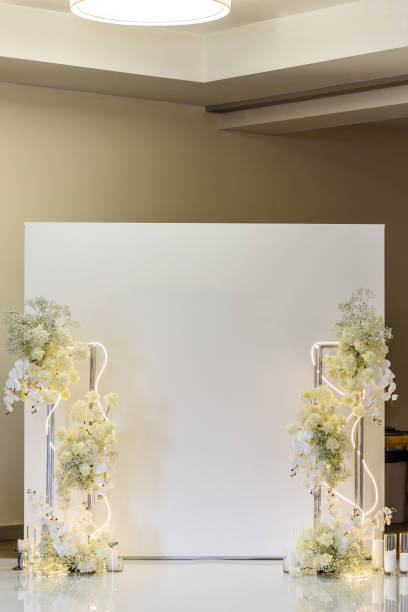 istock Wedding reception for luxury ceremony. Copy space. Celebration baptism concept. Photo-wall, arch place decorated candles and flowers, greenery. Trendy decor for birthday party in the banquet area. 1457726521