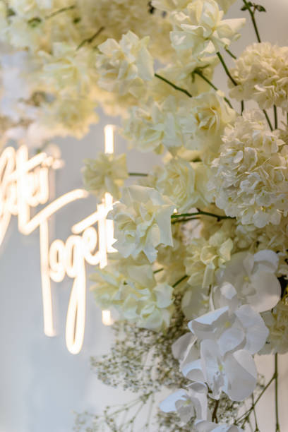 istock Details closeup. Wedding reception for luxury ceremony. Celebration baptism concept. Photo-wall, arch place decorated flowers, greenery. Trendy decor for birthday party in banquet area. 1457726523