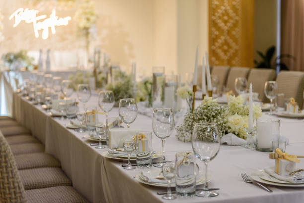 istock Table setting. Wedding banquet decoration in hall restaurant. Wedding setup. Luxury wedding reception. Festive arch decorated composition flowers and candles. Table covered a tablecloth in party area. 1457726541
