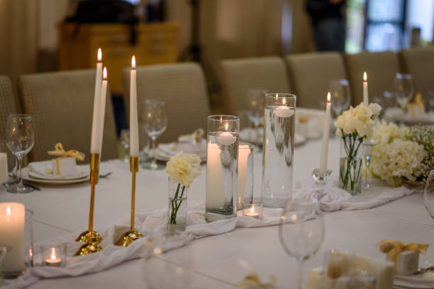 istock Festive table decorated composition flowers and candles in party area. Table setting, serving closeup. Wedding setup detail. Banquet decoration in hall restaurant. Luxury reception. 1457726573
