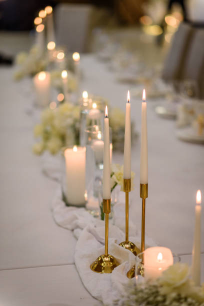 istock Table setting, serving closeup. Wedding setup detail. Banquet decoration in hall restaurant. Luxury reception. Festive table covered tablecloth, decorated composition flowers and candles in party area 1457726574