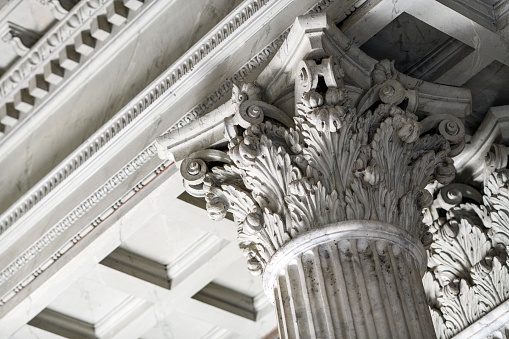 Base of column with colored plaster wall and frame of a classic Italian church - toned image with copy space