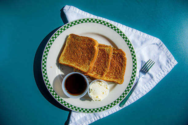 Indulge in a sweet breakfast treat with this mouthwatering French toast, caramel sauce and powdered sugar closeup view