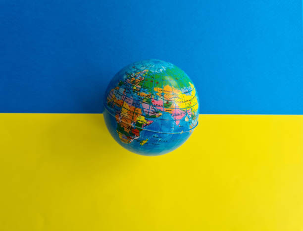 istock World globe Ukrainian flag background blue and yellow 1457731648