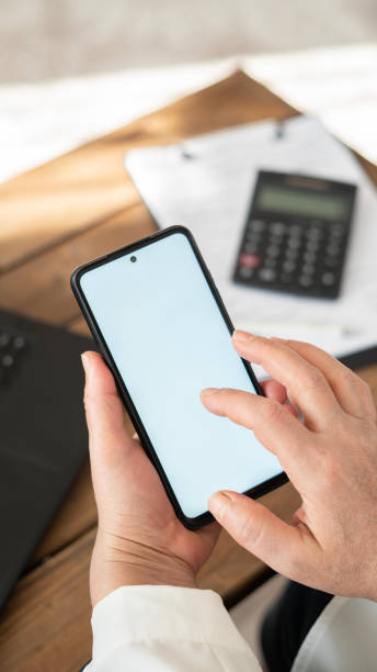 istock Close-up Woman using phone with blank screen at home 1457732195