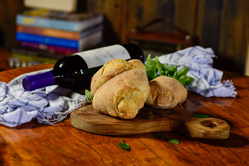 Bottle of wine and delicious freshly baked homemade bread.