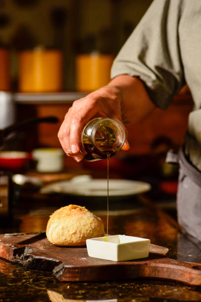 istock Woman putting oil in a container. freshly baked bread 1457732226