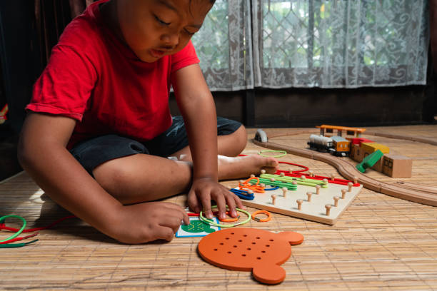 istock an asian little boy playing geometric nail plate, a creative game for early development and good motor skills 1457736605