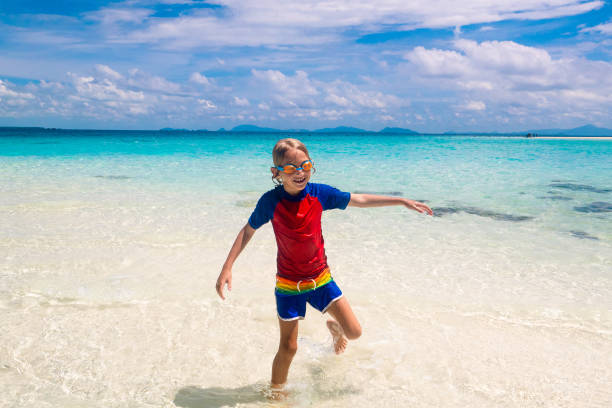 istock Kids playing on beach. Children play at sea. 1457736772