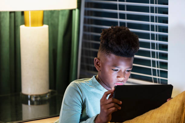 istock Multiracial boy watching movie on digital tablet 1457736967