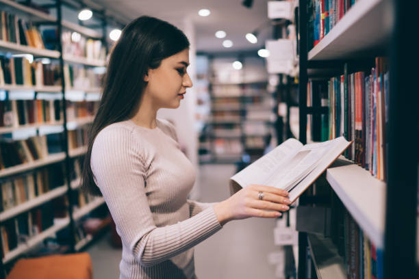 istock Gorgeous woman enjoying interesting story in library 1457738244