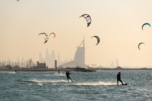 January 12th 2023, Dubai UAE, A view of Kite surfers practicing kitesurfing with the backdrop of the iconic Burj Al Arab hotel in the background