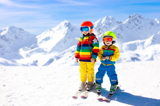 ski and snow winter fun for kids. children skiing. - snow gear imagens e fotografias de stock