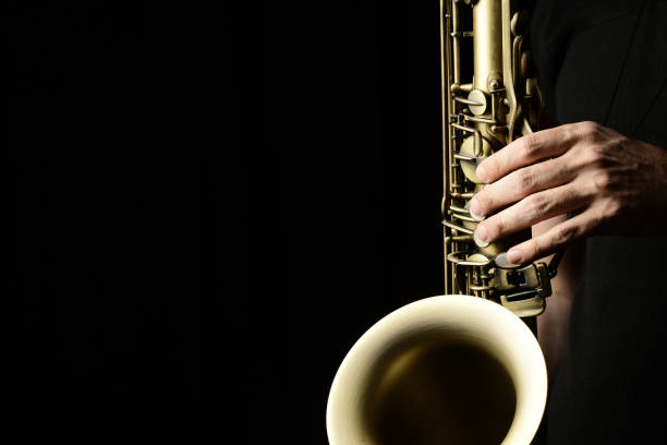 istock Musician's hands playing the saxophone 1457739339