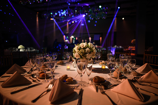 Decorated table with zenithal illumination and blurred background of lights.