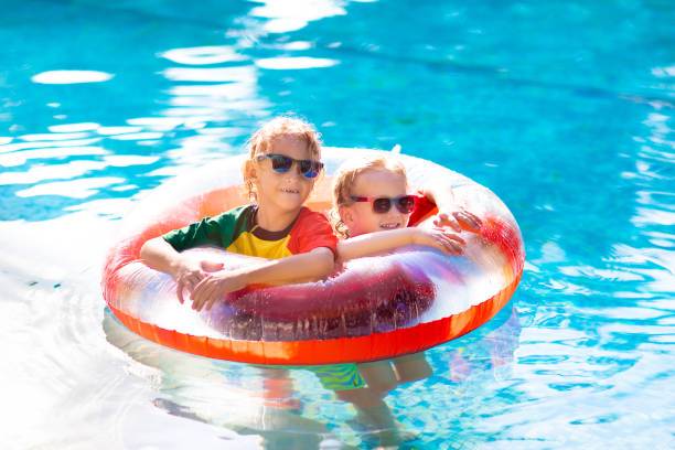 istock Kids in swimming pool. Life jacket for child. 1457739462