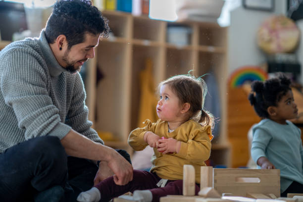 istock Male Daycare Educator with Children 1457739700