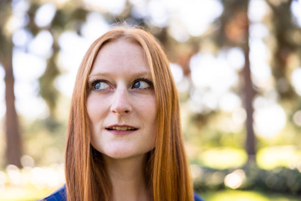 A young beautiful red-haired girl outdoors