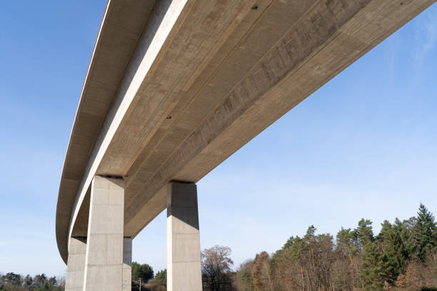 istock Modern concrete highway bridge from below in the countryside with blue sunny sky 1457741413