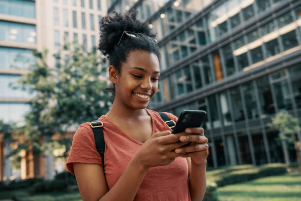istock Young African American woman using smart phone, and using mobile banking app 1457741553