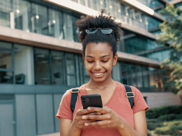 istock Young African American woman using smart phone, and using mobile banking app 1457741554