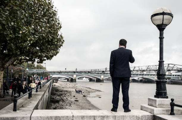 bankside businessman - beach stone wall one person imagens e fotografias de stock