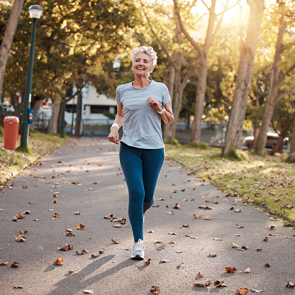 Park, running and fitness with a senior woman outdoor for cardio or endurance training in summer. Sports, exercise and health with a mature female pensioner outside for a run during retirement