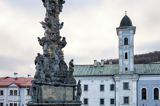 Franciscan church and Plague column in a square in historic centre of Kremnica, Slovakia, Europe.