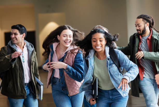 istock Two young women, college students going to class, laughing 1457745516