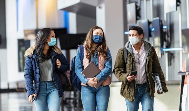 istock College students walking, wearing face masks 1457745573