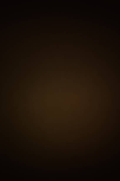 istock dark brown soft background with a round gradient light spot in the center. moody artistic studio backdrop with vignette 1457745885