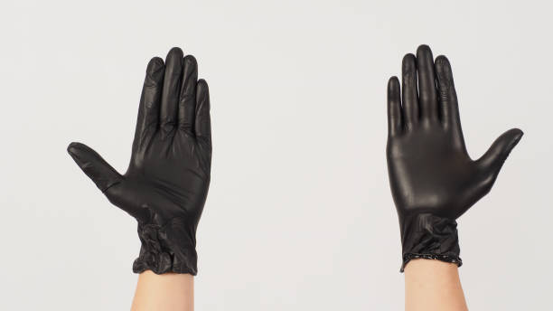 istock Two Hands is wear black latex gloves on white background. 1457748378