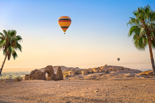 Hot air balloon over ruins of Hatshepsut temple in Luxor, Egypt