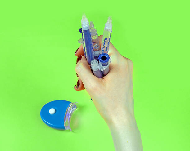 istock Female hand holding plastic syringes 1457748695