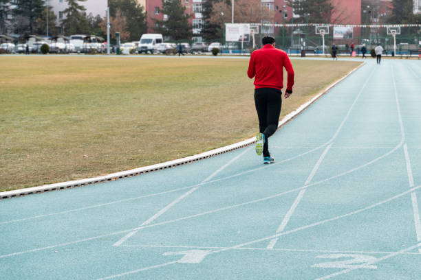 istock young man doing sports on the running track 1457749735