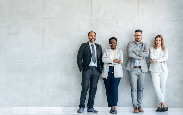 Portrait of Business team Portrait of multi ethnic business team in the office. Multi-ethnic group of business persons standing side by side. Cheerful business team embracing each other. Looking happy and confident for successful teamwork group of people standing together stock pictures, royalty-free photos & images