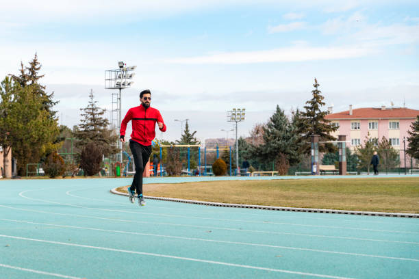 istock young man doing sports on the running track 1457749784